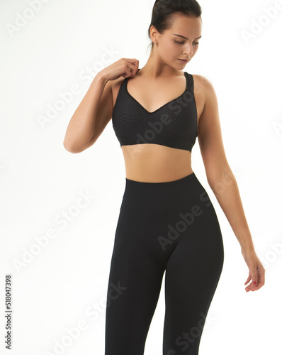 Perfect slim tanned young female body in sportswear. Concept perfect body, no fat, motivation, healthy lifestyle, fitness routine. Isolated white background.