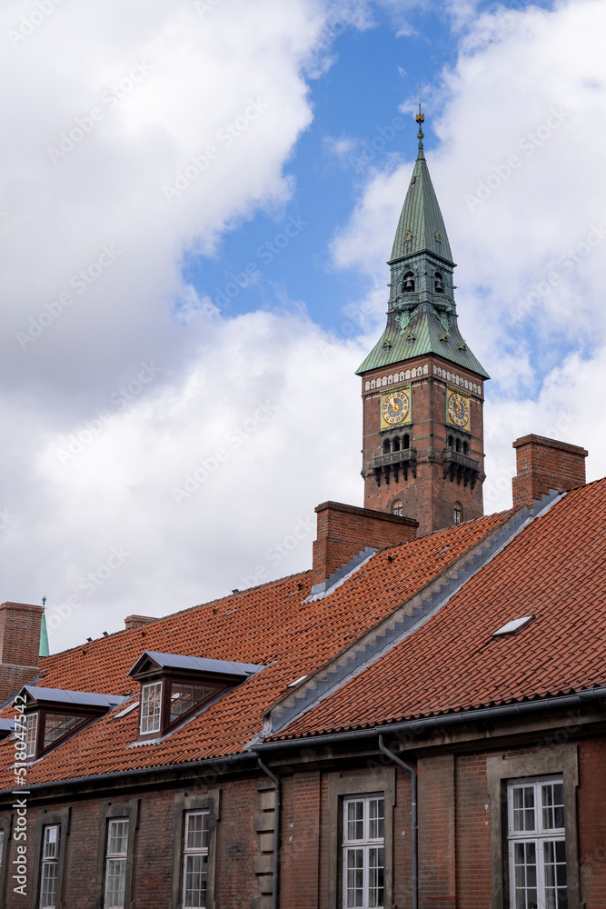 Copenhagen City Hall and Clock Tower Viewed from Over Rooftops on a Sunny Day during Daytime. Copenhagen City Hall and Clock Tower Viewed from Over Rooftops on a Sunny Day during Daytime.