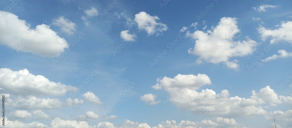 white clouds clumping up in the bright blue sky. white clouds clumping up in the bright blue sky.