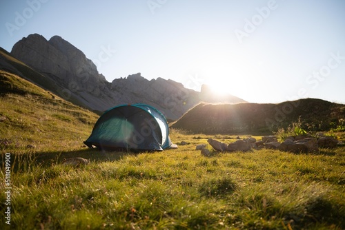 Tent set up in the mountain at sunrise in French Alps