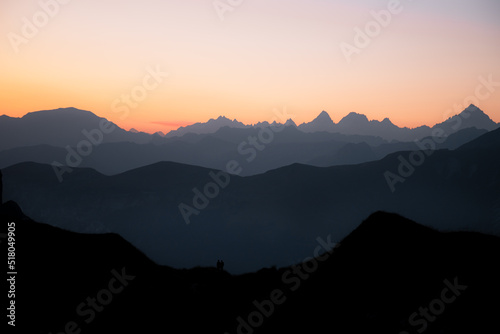 First sunlight on the mountains of the Lac de Peyre in French Alps. Mountain layers at blue hour at sunrise