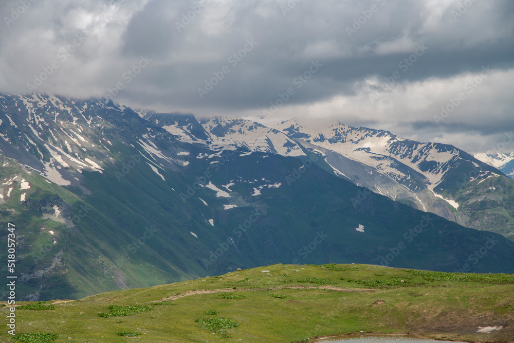 Beautiful mountains landscape. Panoramic view on the green hills and mountains under clouds .