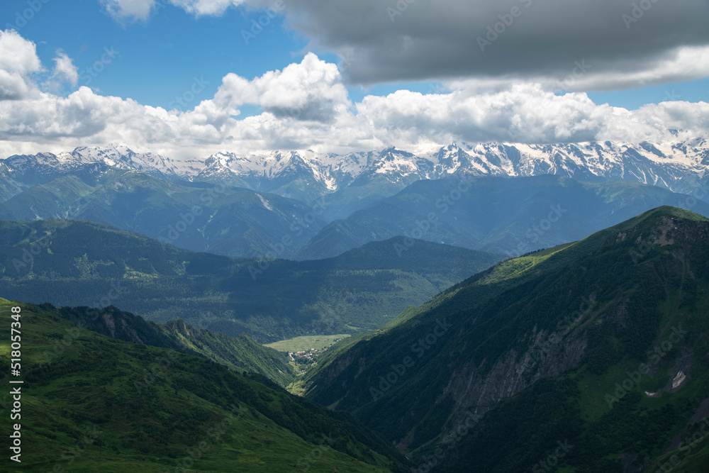 Beautiful mountains landscape. Panoramic view on the green hills and mountains under clouds .