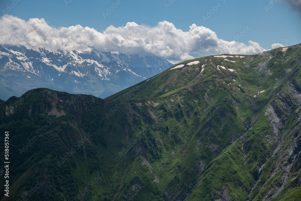 Naklejka premium Beautiful mountains landscape. Panoramic view on the green hills and mountains under clouds .