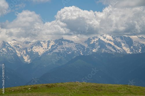 Beautiful mountain landscape. High snow covered mountains in the fog .