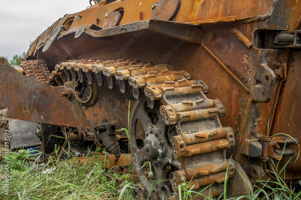 Rusty caterpillar of a wrecked tank.
