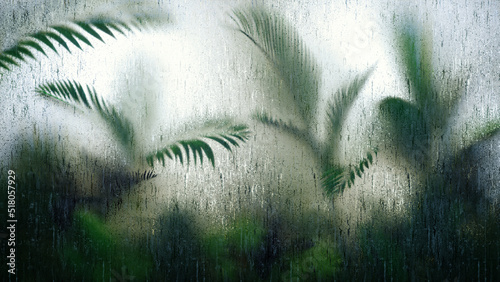 Blurred tropic leaves behind Frosted glass with waterdrops. Glassmorphism. Tropical leaf background. 3d illustration. photo