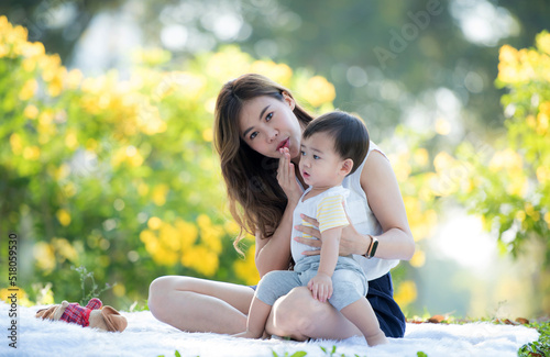 Portrait of asian mother playing with newborn baby, baby talking to mother. Health care family love together. Asian girl lifestyle. Asia mother's day concept
