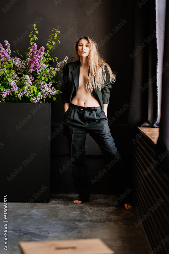 a sexy blonde topless woman in a black jacket in a dark room a sexy blonde topless woman in a black jacket in a dark room