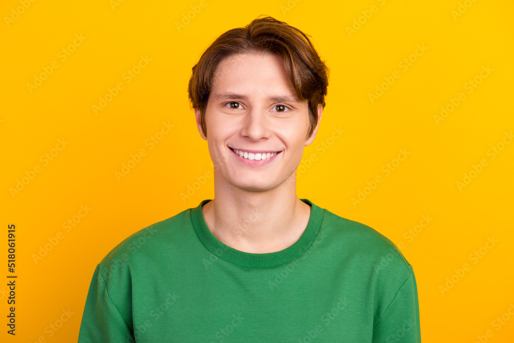 Handsome caucasian man smiling with white teeth, looking confident at camera standing in green shirt on bright background Handsome caucasian man smiling with white teeth, looking confident at camera standing in green shirt on bright background