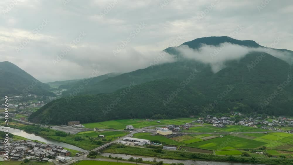 Hyperlapse: Morning fog on mountain over rice fields and country town in valley Hyperlapse: Morning fog on mountain over rice fields and country town in valley