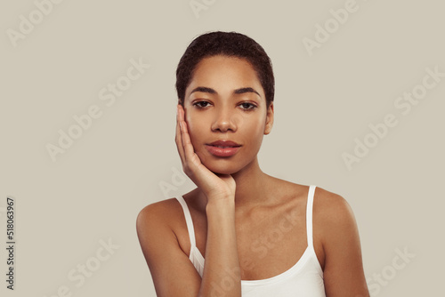 Attractive african american woman with perfect skin on white background