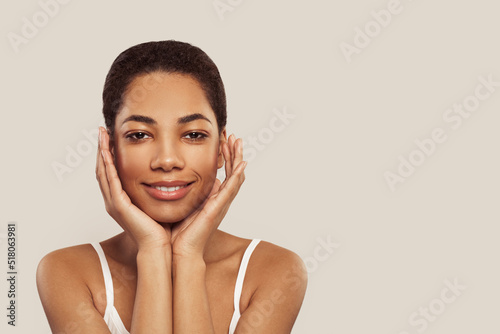 Happy african american woman touching soft smooth skin on her face on white background