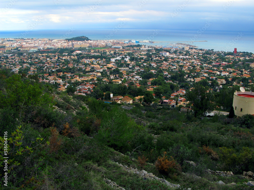 Denia, view of the city from above from Mount Montgó. Roofs of houses, the sea in the distance, Spain