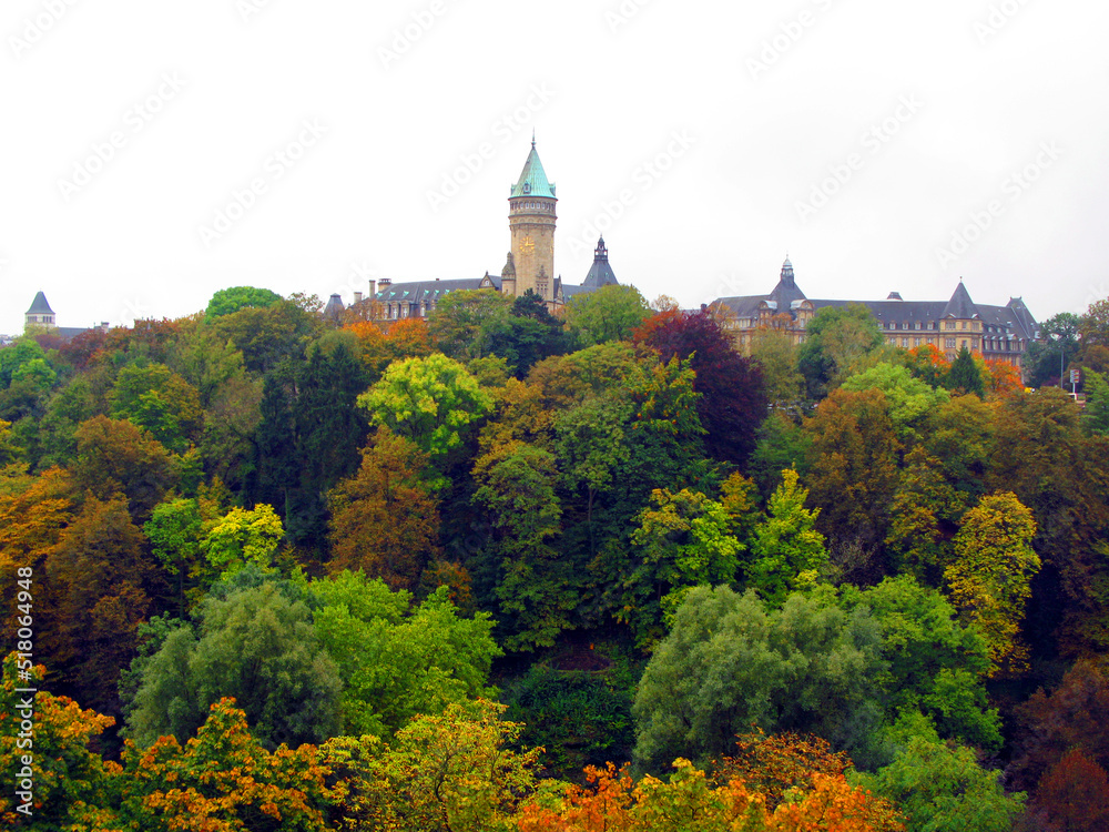 Luxembourg, view of the city from afar. Autumn green, red, yellow trees, spiers of towers of old houses in the distance. Beautiful landscape