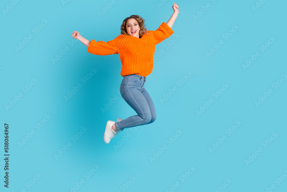 Full size photo of cool brunette millennial lady jump fist up victory isolated on green cyan color background