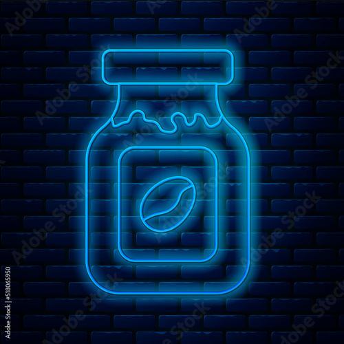Glowing neon line Coffee jar bottle icon isolated on brick wall background. Vector