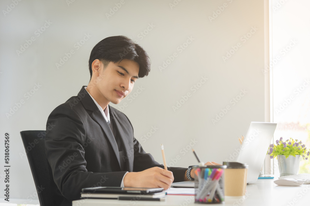 Business Asian man working with smiling and happy emotion in modern office workplace. Business Asian man working with smiling and happy emotion in modern office workplace.