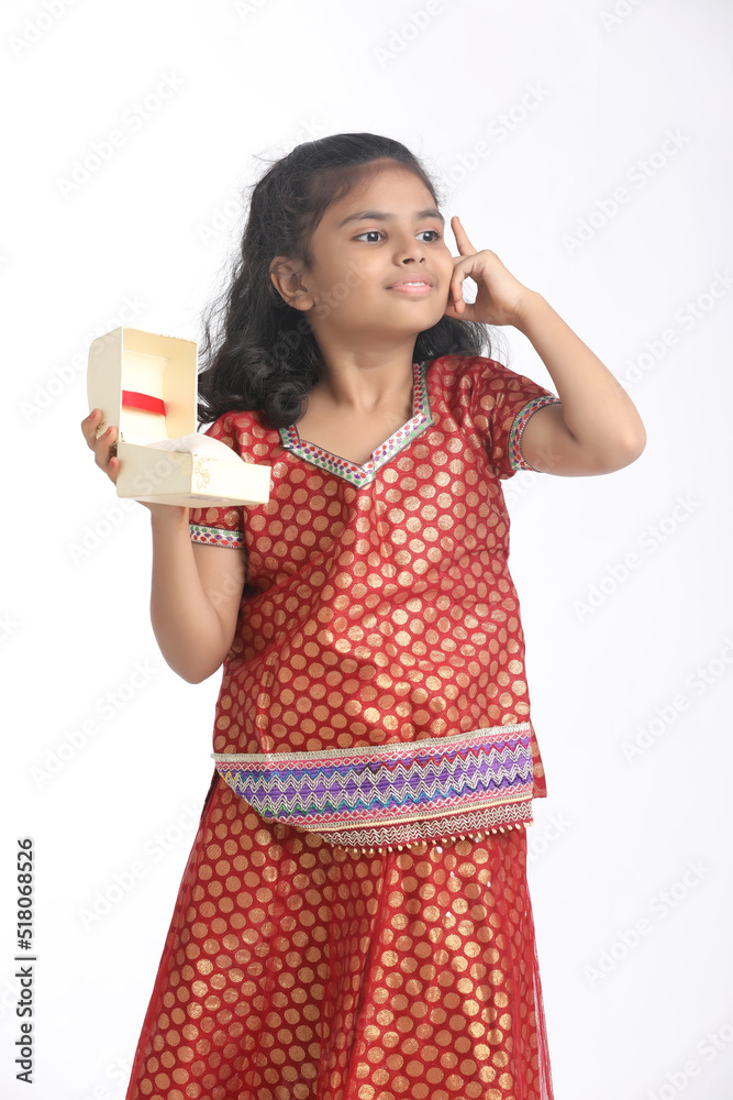 Indian little girl recieved gift and thinking some idea Indian little girl recieved gift and thinking some idea