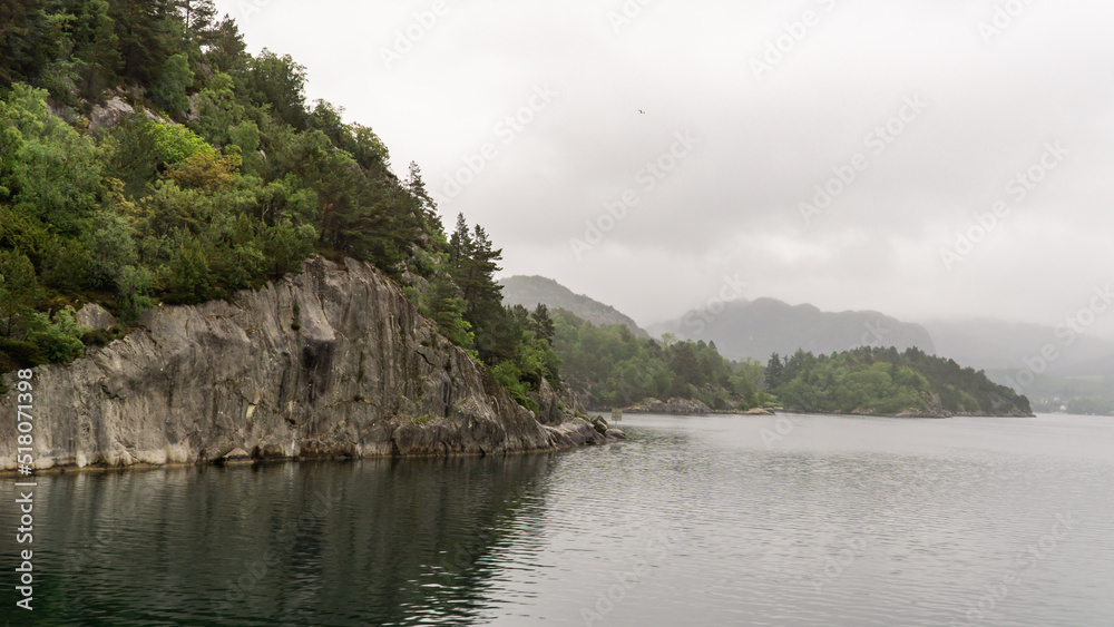 Lysefjord landscape with cliffs in the foreground and the reflection of the water on a cloudy day. Lysefjord landscape with cliffs in the foreground and the reflection of the water on a cloudy day.