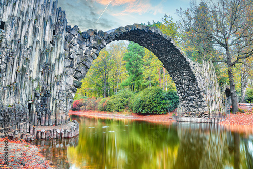 Unbelievable autumn landscape in Azalea and Rhododendron Park Kromlau. Rakotz Bridge (Rakotzbrucke, Devil's Bridge)