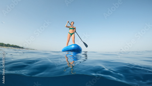 Girl on stand up paddle sup board in the sea