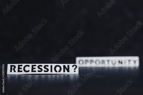 recession or opportunity texts over dark background with only one in focus