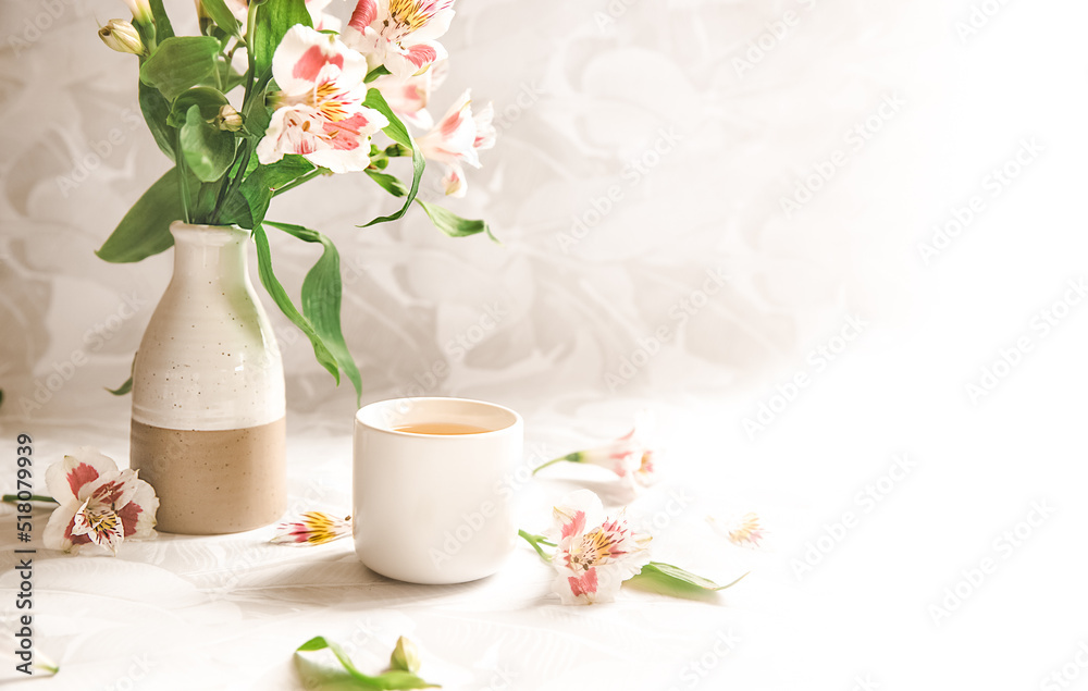 flower and herb tea in a tea cup on neutral background with space for your text. Morning tea