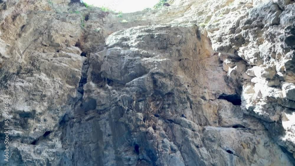 Bottom up view natural well of karst-tectonic origin known as Proval located on southern slope of Mount Mashuk in Pyatigorsk, At bottom of well is karst lake of turquoise mineral water, North Caucasus Bottom up view natural well of karst-tectonic origin known as Proval located on southern slope of Mount Mashuk in Pyatigorsk, At bottom of well is karst lake of turquoise mineral water, North Caucasus