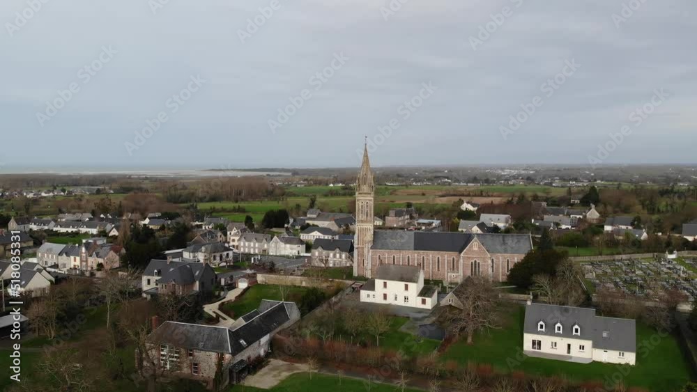 Bricqueville-sur-Mer, France 22.7.22 aerial drone view of city church on blue sky with clouds. typical french normandy cityscape. rural and beautifu countryside concept Bricqueville-sur-Mer, France 22.7.22 aerial drone view of city church on blue sky with clouds. typical french normandy cityscape. rural and beautifu countryside concept