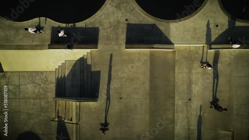 Overhead view of Venice Skate Park at sunset with long shadows of skaters