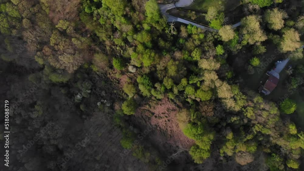 Drone flying over several isolated rural houses at the base of a green valley. Rural tourism concept Drone flying over several isolated rural houses at the base of a green valley. Rural tourism concept