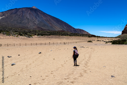 Woman on La Canada de los Guancheros dry desert plain with view on volcano Pico del Teide  Mount El Teide National Park  Tenerife  Canary Islands  Spain  Europe. Hiking to Riscos de la Fortaleza