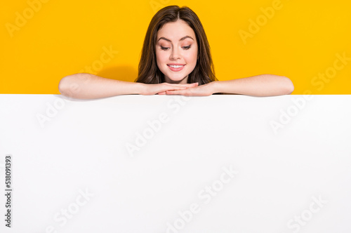 Fotografía Photo of satisfied funky girl hide behind empty space blank look down isolated o