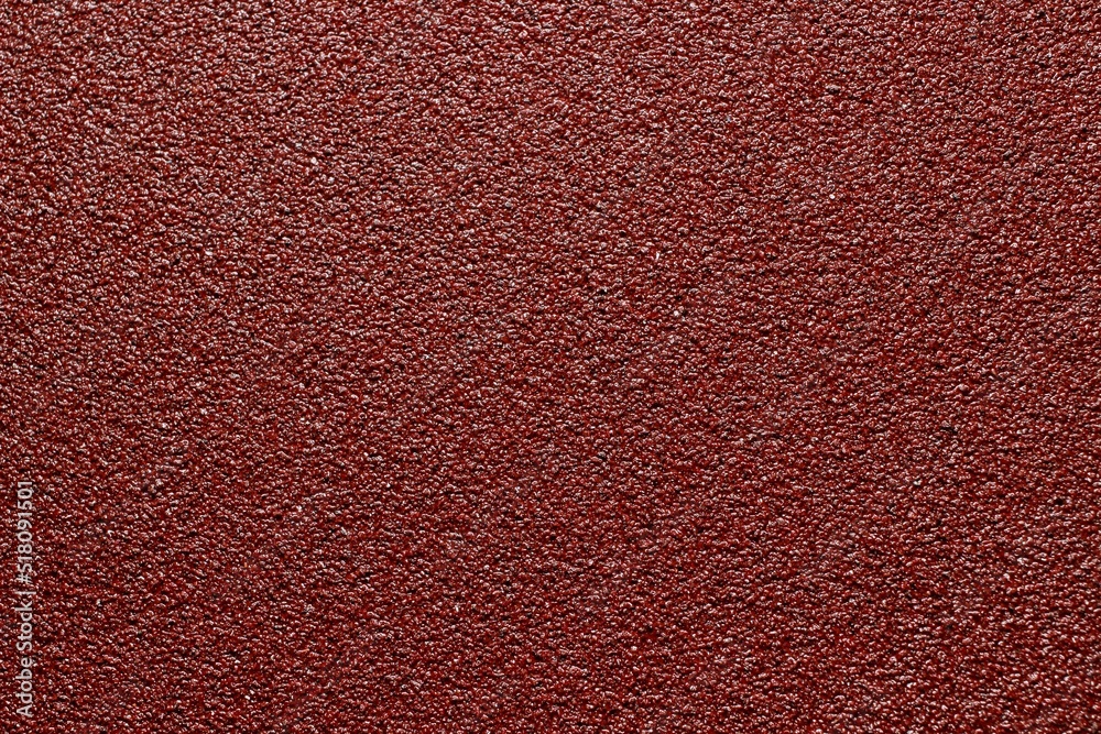 Fototapeta premium sandpaper red color close up background texture
