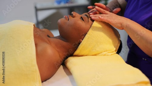 african woman in wellow towel on facial massage	 photo