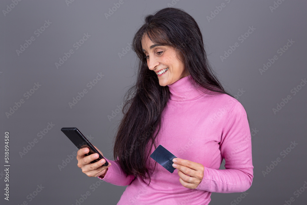 smiling woman with card and smart phone in hand smiling woman with card and smart phone in hand