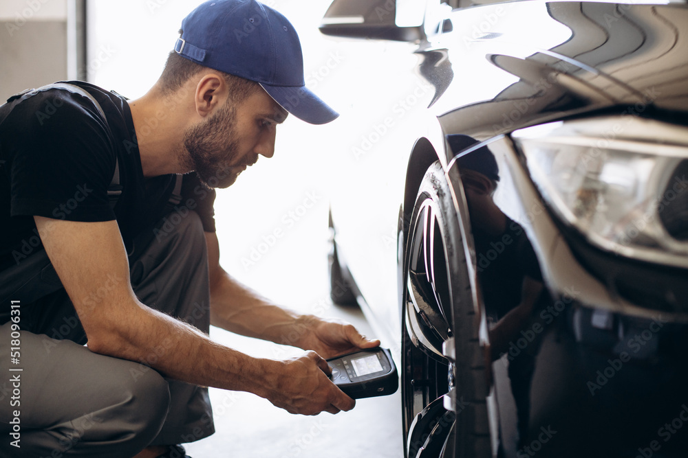 Repairman checking pressure sensors with a special tool Repairman checking pressure sensors with a special tool