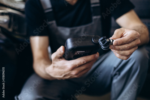 Repairman checking pressure sensors with a special tool photo