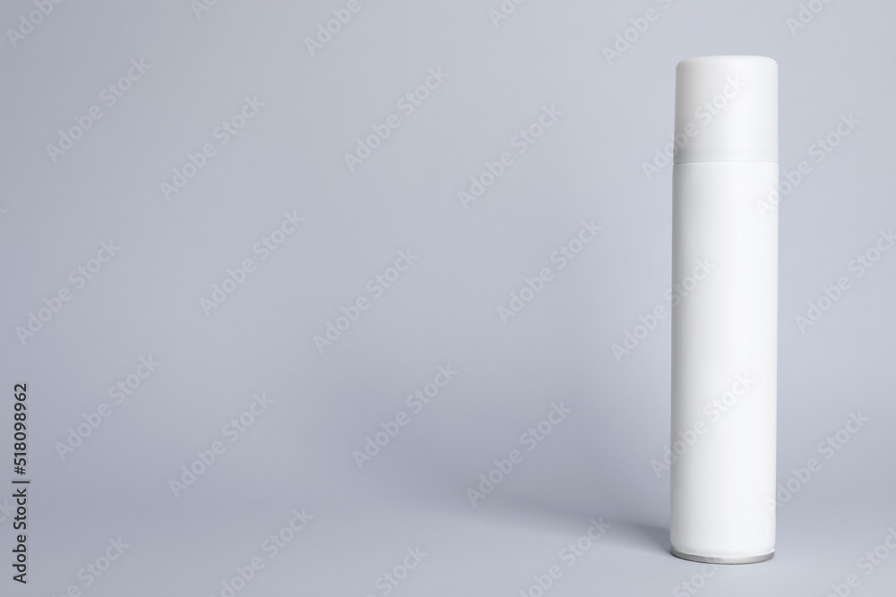 Bottle of dry shampoo on grey background, space for text Bottle of dry shampoo on grey background, space for text