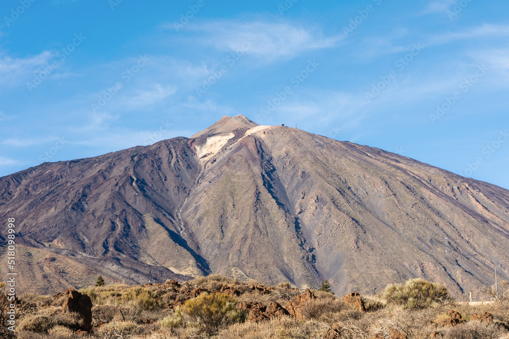 Panoramic view of unique Roque Cinchado unique rock formation with famous Pico del Teide mountain volcano summit in the background on a sunny day, Teide National Park, Tenerife, Canary Islands, Spain Panoramic view of unique Roque Cinchado unique rock formation with famous Pico del Teide mountain volcano summit in the background on a sunny day, Teide National Park, Tenerife, Canary Islands, Spain