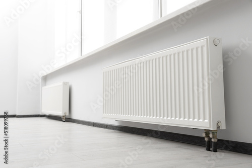 Modern radiators in room. Central heating system