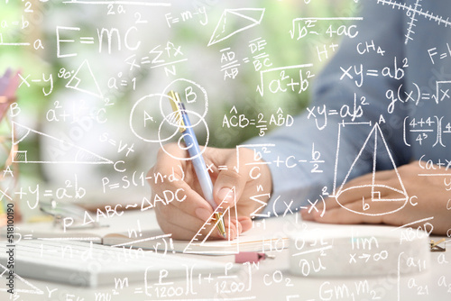 Science and education concept. Illustration of basic physics and mathematics formulas and woman working at table, closeup photo