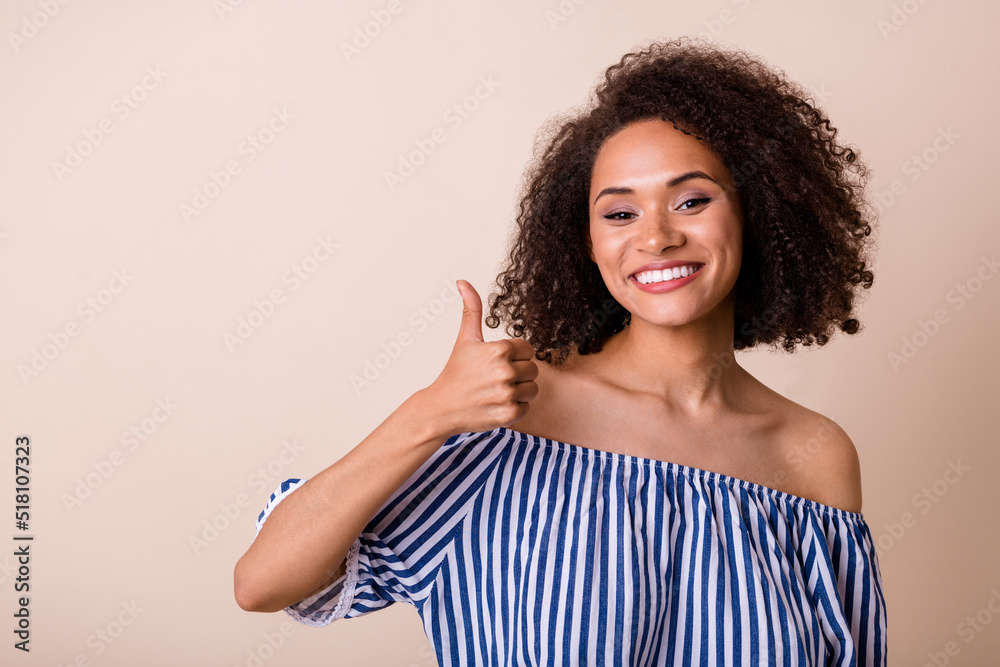 Portrait of pretty friendly person hand finger demonstrate thumb up isolated on beige color background Portrait of pretty friendly person hand finger demonstrate thumb up isolated on beige color background