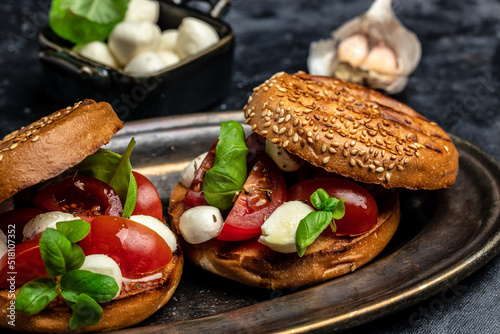 Healthy Grilled Basil Mozzarella Caprese Panini Sandwich on a dark background. Delicious breakfast or snack, Clean eating, dieting, vegan food concept. top view