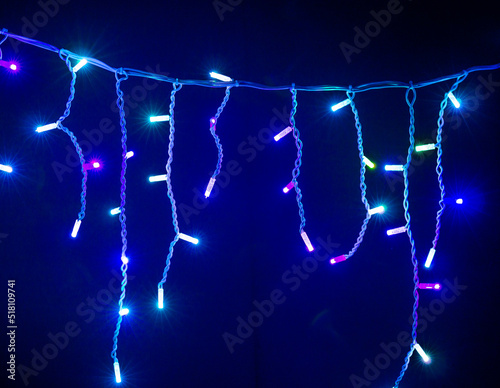Colored Christmas garlands on a black background