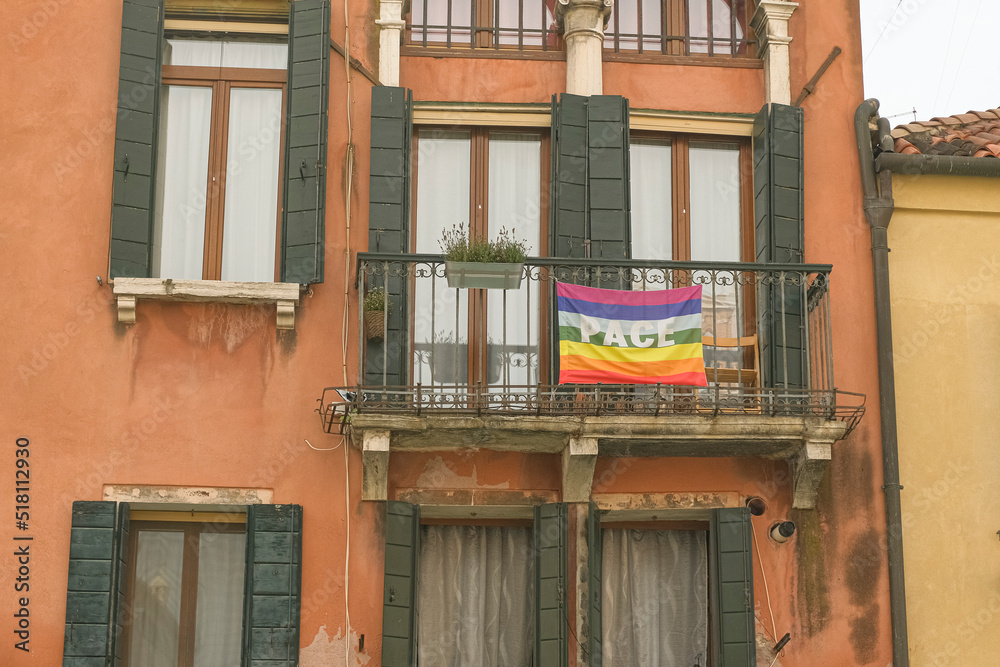 Rainbow peace flag exposed on city house facade to support stop war in Ukraine. 