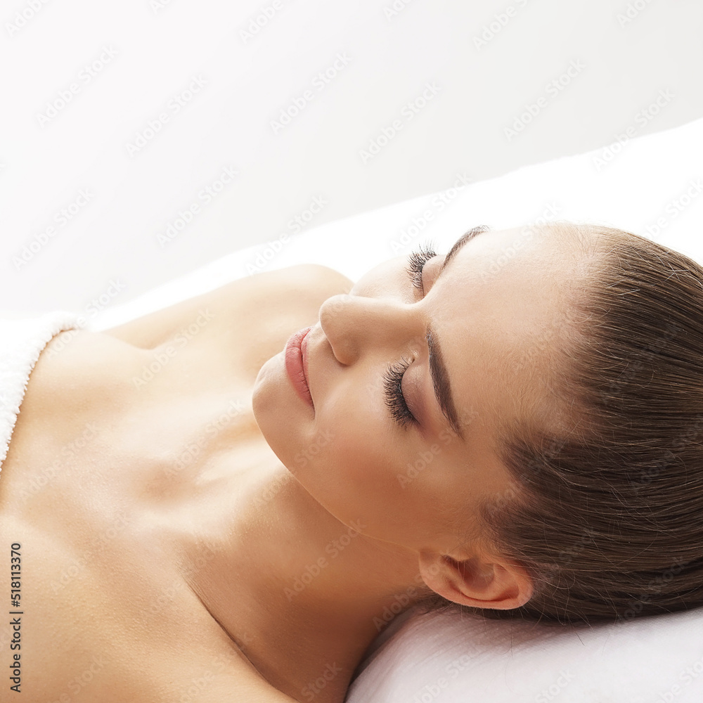 Beautiful, young and healthy woman having face massage in spa salon. Hands of professinal masseur. Spa, health and healing concept. Beautiful, young and healthy woman having face massage in spa salon. Hands of professinal masseur. Spa, health and healing concept.