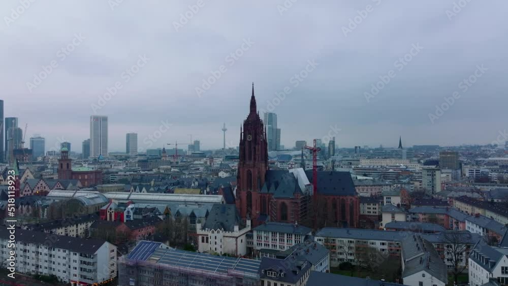 Frankfurter Dom. Historic gothic church between buildings in town centre. Overcast sky above city. Frankfurt am Main, Germany Frankfurter Dom. Historic gothic church between buildings in town centre. Overcast sky above city. Frankfurt am Main, Germany