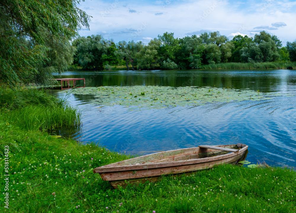 boat moored near the river bank, wooden fishing boat in the village